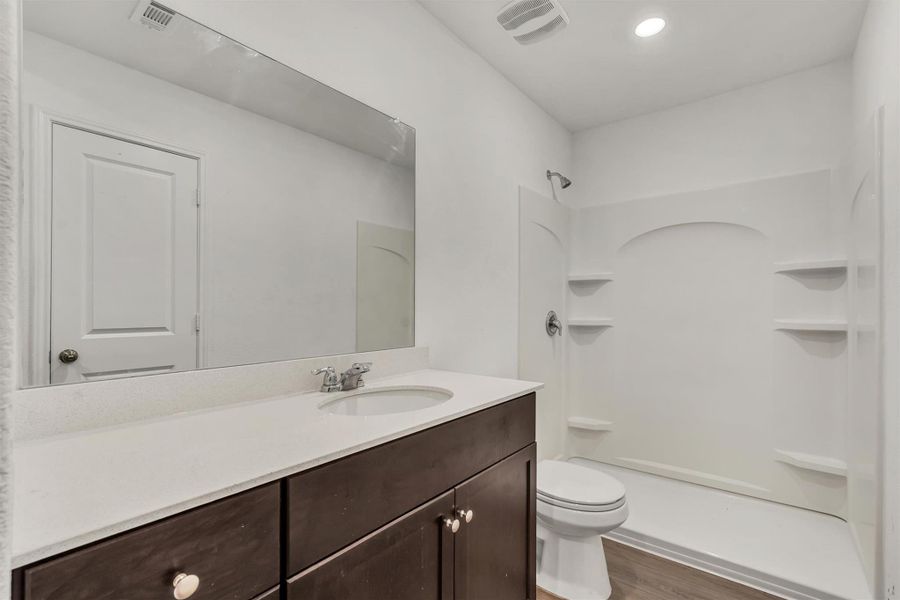 Clean lines and a spacious vanity highlight this modern secondary bathroom. Clean lines and a spacious vanity highlight this modern secondary bathroom.