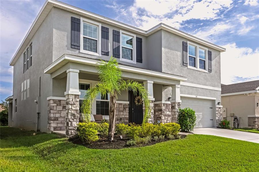 Front exterior of a new home in , Apollo Beach, FL, highlighting curb appeal (Image 24).
