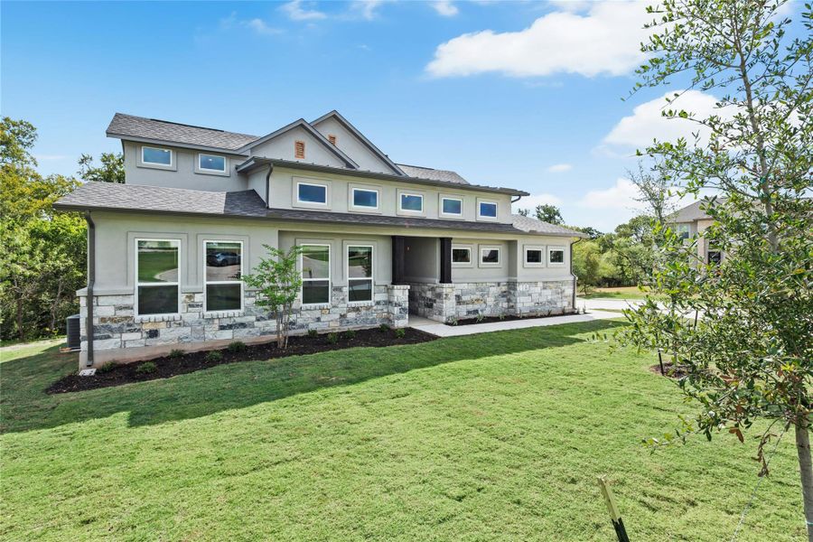 View of front of house featuring stone siding, a front yard, stucco siding, and roof with shingles View of front of house featuring stone siding, a front yard, stucco siding, and roof with shingles
