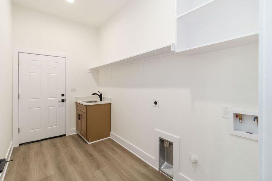 Spacious Laundry area  with washer/dryer hook ups and Sink