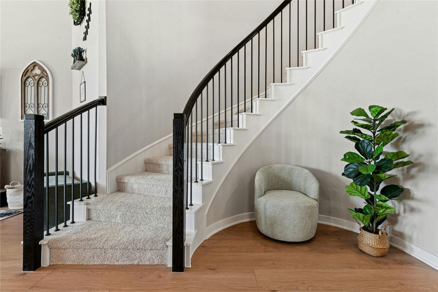 Stairway featuring wood finished floors and baseboards