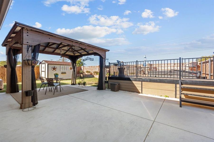 View of patio with a gazebo and a storage shed