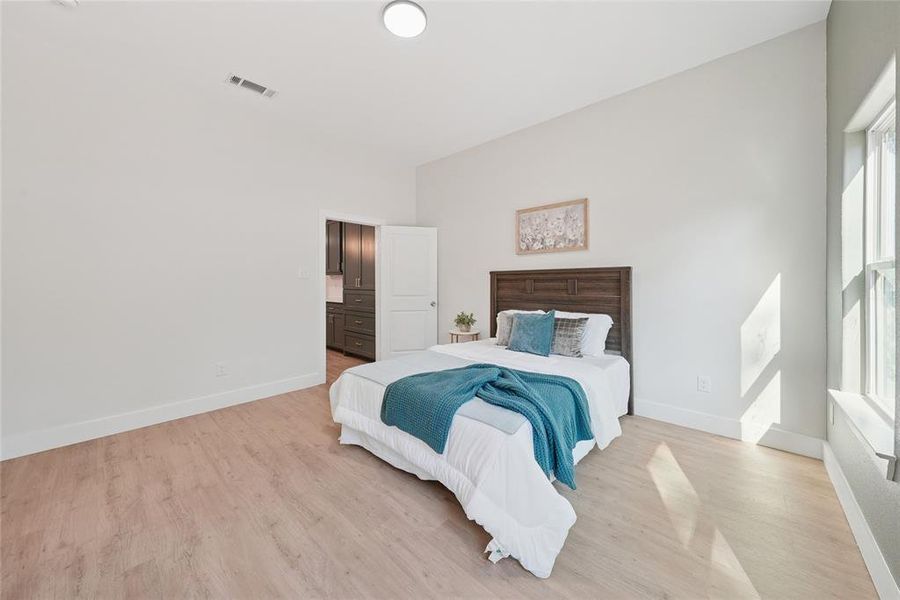 Bedroom featuring light wood finished floors and baseboards