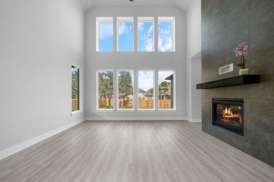 Family Room with soaring ceiling & fireplace