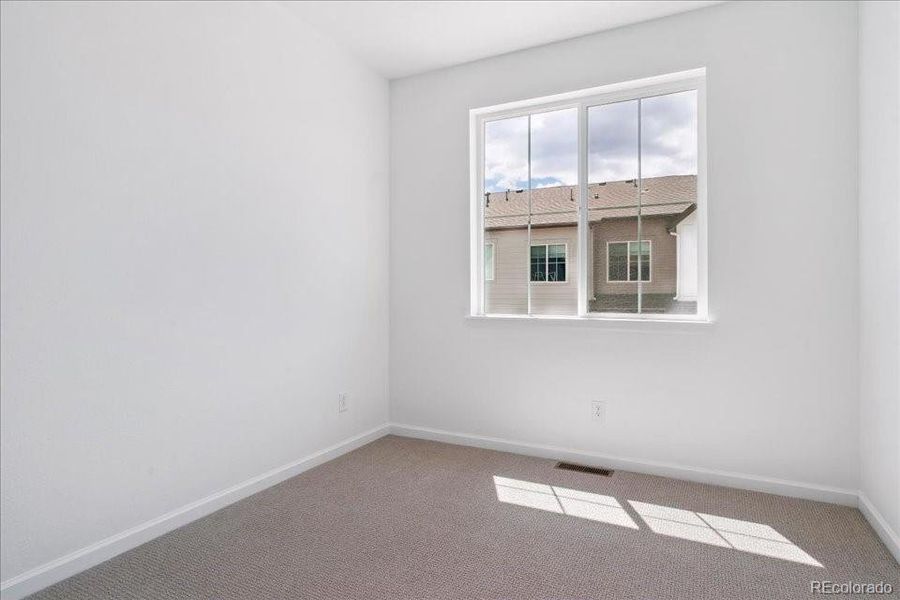 Spacious, unfurnished interior of a new home in Pacific Collection at The Townes at Skyline Ridge, Castle Pines (Image 14).
