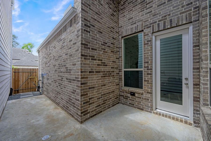 Exterior details and patio area of a home in Woodforest Townhomes, Montgomery (Image 3).