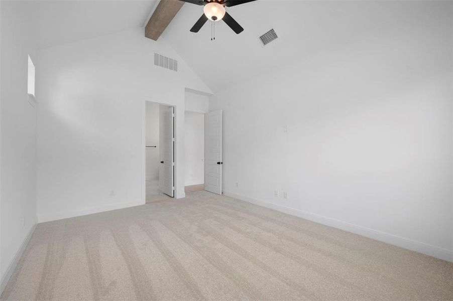 Unfurnished bedroom with light carpet, a ceiling fan, and ensuite bathroom