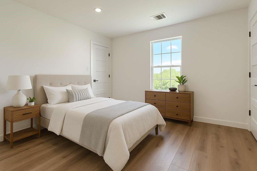 Second bedroom with walk-in closet to the left and entrance to Jack and Jill bathroom on the right. Virtually staged.