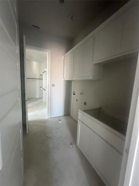Primary closet conveniently connects to the utility room