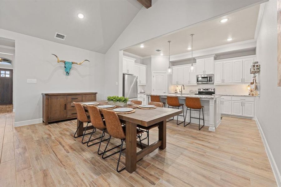 Dining room with recessed lighting and light wood-type flooring
