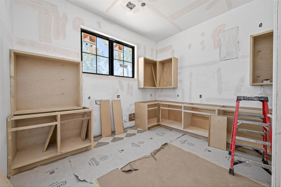 Utility room with custom cabinetry and extra sink