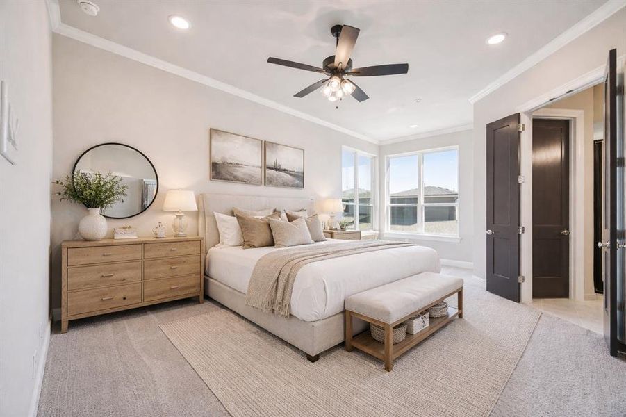 Primary bedroom with seating area near windows.