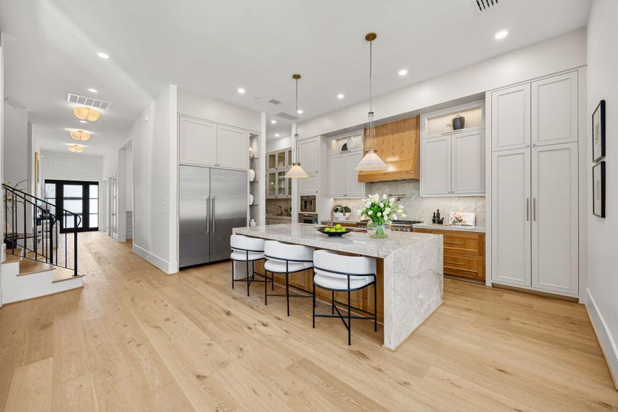 Chef's Kitchen offers a Large Quartzite island w/ waterfall edge, Large 48" fridge, 48 in high-end range, Thermador coffee maker, custom site built cabinetry. Chef's Kitchen offers a Large Quartzite island w/ waterfall edge, Large 48" fridge, 48 in high-end range, Thermador coffee maker, custom site built cabinetry.