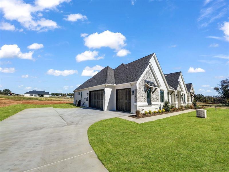 View of front of home featuring a garage and a front lawn