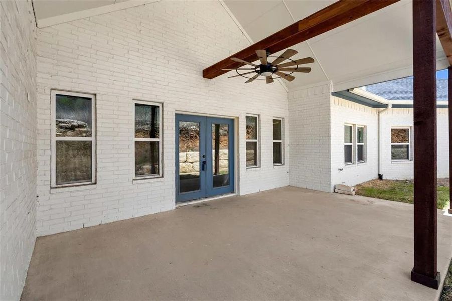View of patio with a ceiling fan and french doors
