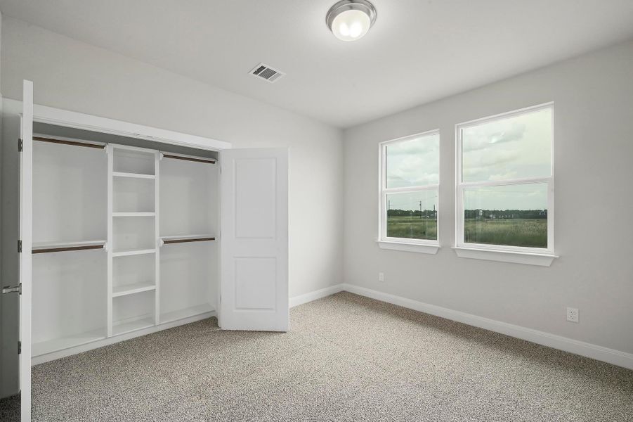 Unfurnished bedroom with carpet floors, lofted ceiling, and a closet Unfurnished bedroom with carpet floors, lofted ceiling, and a closet