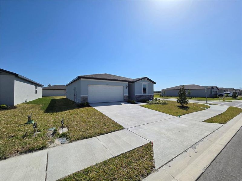 Front exterior of a new home in Magnolia Bay - Classic Series, Nokomis, FL, highlighting curb appeal (Image 1).