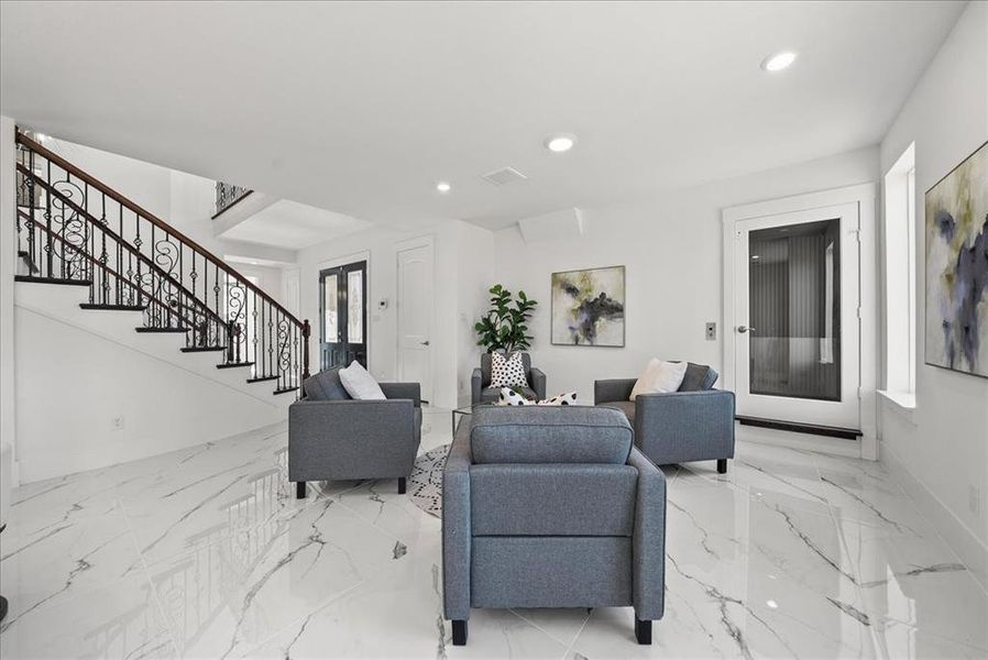 Living area featuring, light marble floors, elevator access, and recessed lighting Living area featuring, light marble floors, elevator access, and recessed lighting