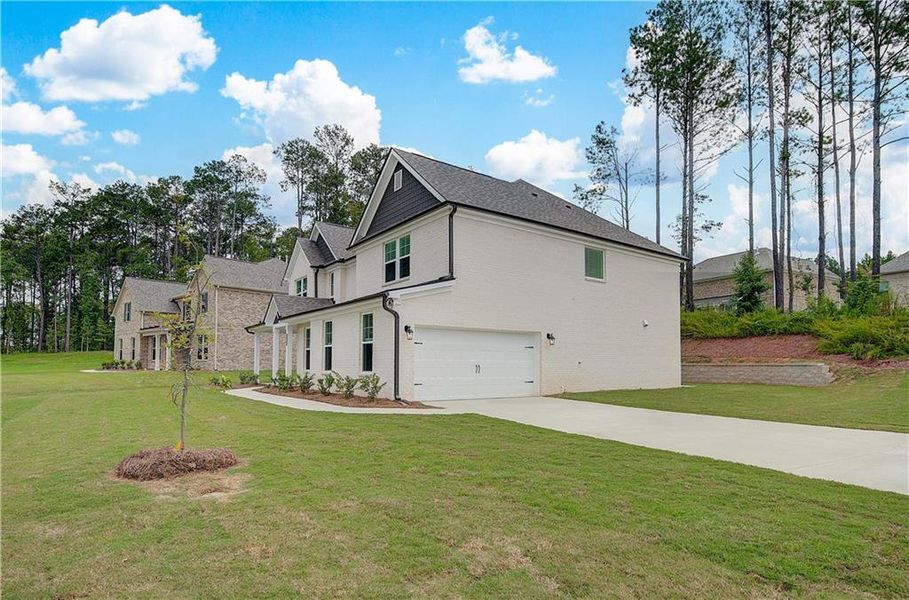 Front exterior of a new home in Trinity Park, McDonough, GA, highlighting curb appeal (Image 16).