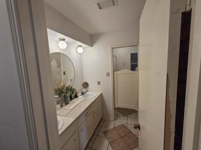Full bathroom featuring light tile patterned floors and double vanity Full bathroom featuring light tile patterned floors and double vanity
