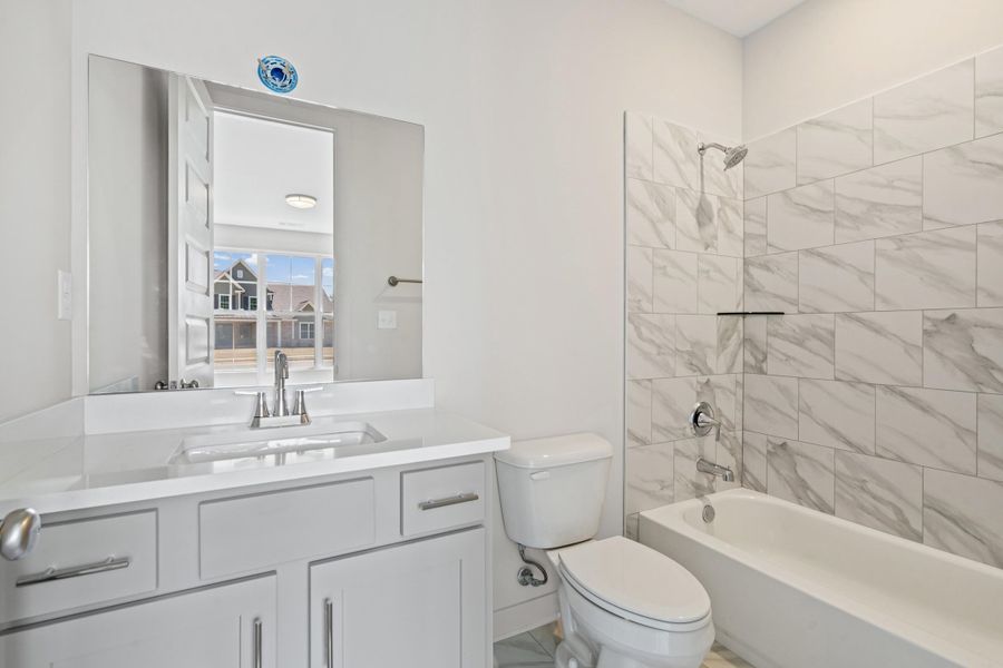 Bathroom with vanity and shower / washtub combination