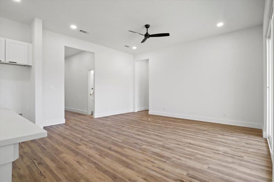 Unfurnished living room featuring light wood-type flooring, recessed lighting, and ceiling fan