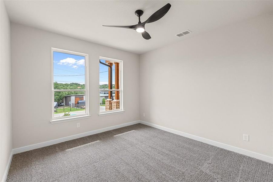 Unfurnished room featuring carpet and ceiling fan