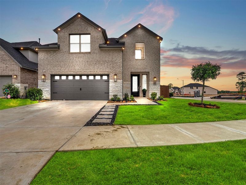 Front exterior of a new home in The Trails, New Caney, TX, highlighting curb appeal (Image 28).