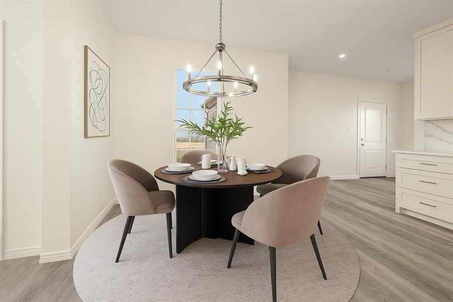 Dining area with light wood finished floors, recessed lighting, and a chandelier Dining area with light wood finished floors, recessed lighting, and a chandelier