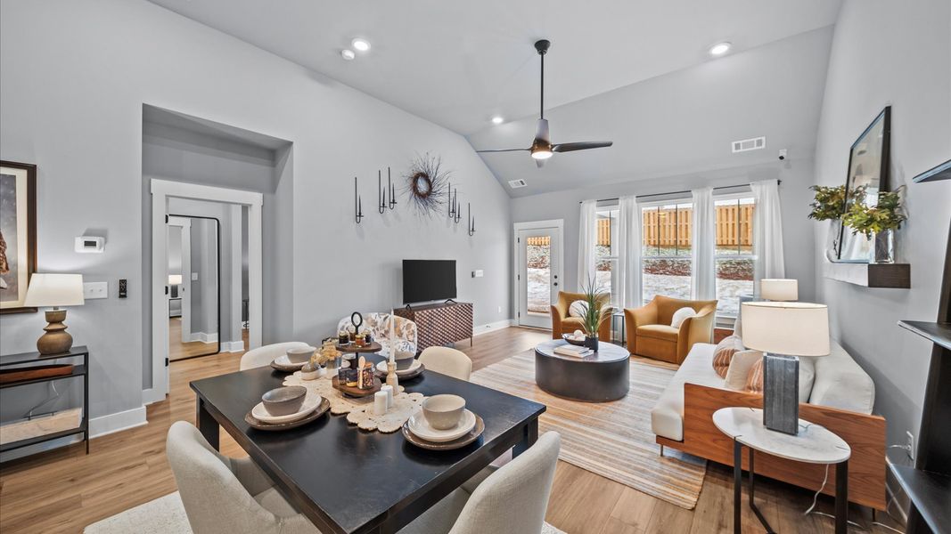 Spacious and stylish family room with two-story ceilings that create a bright and open atmosphere