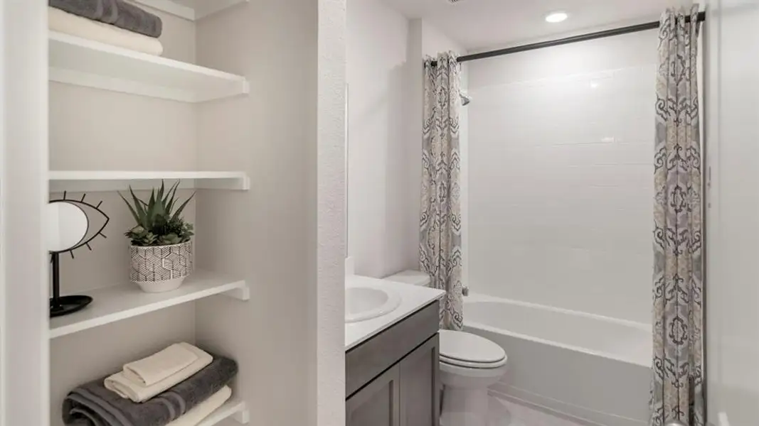 Bathroom with vanity and shower / bathtub combination with curtain