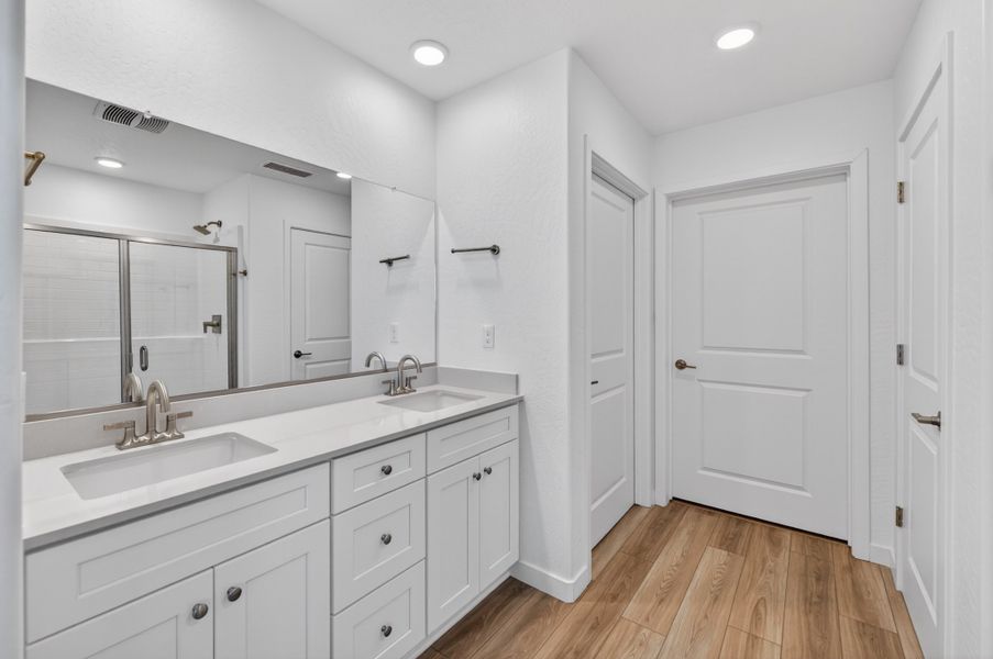 A bathroom with white cabinets. A bathroom with white cabinets.