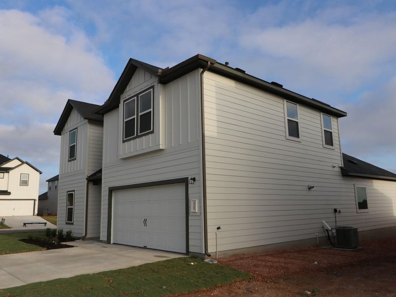 Front exterior of a new home in Cascades at Onion Creek, Austin, TX, highlighting curb appeal (Image 2). Front exterior of a new home in Cascades at Onion Creek, Austin, TX, highlighting curb appeal (Image 2).