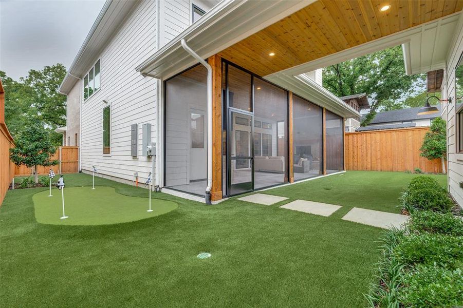 Rear view of property with a fenced backyard, a sunroom, and a yard Rear view of property with a fenced backyard, a sunroom, and a yard