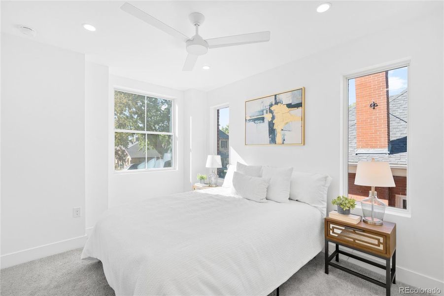 The primary bedroom is filled with natural light, offering a bright and peaceful modern retreat.