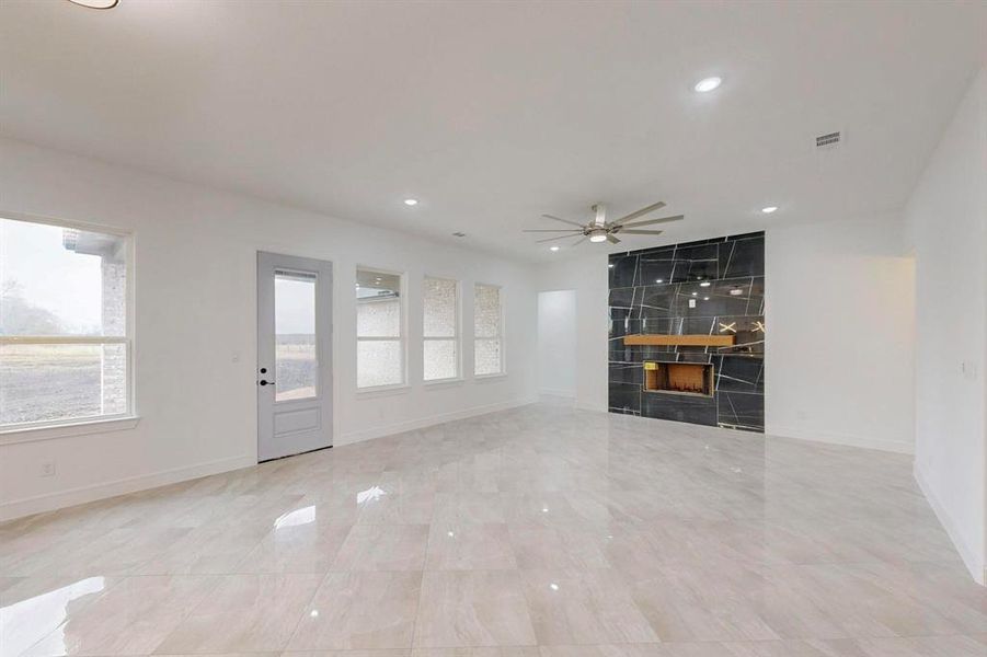 Unfurnished living room with recessed lighting and ceiling fan