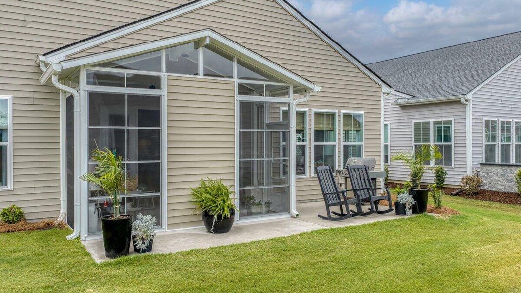 Exterior details and patio area of a home in K. Hovnanian's® Four Seasons at Lakes of Cane Bay, Summerville (Image 27).