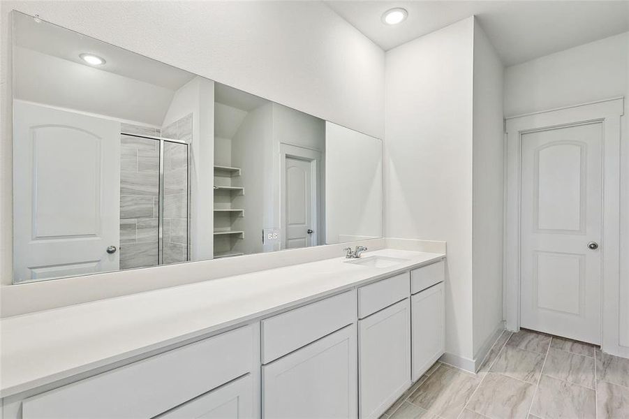 Bathroom with vanity and a shower with shower door