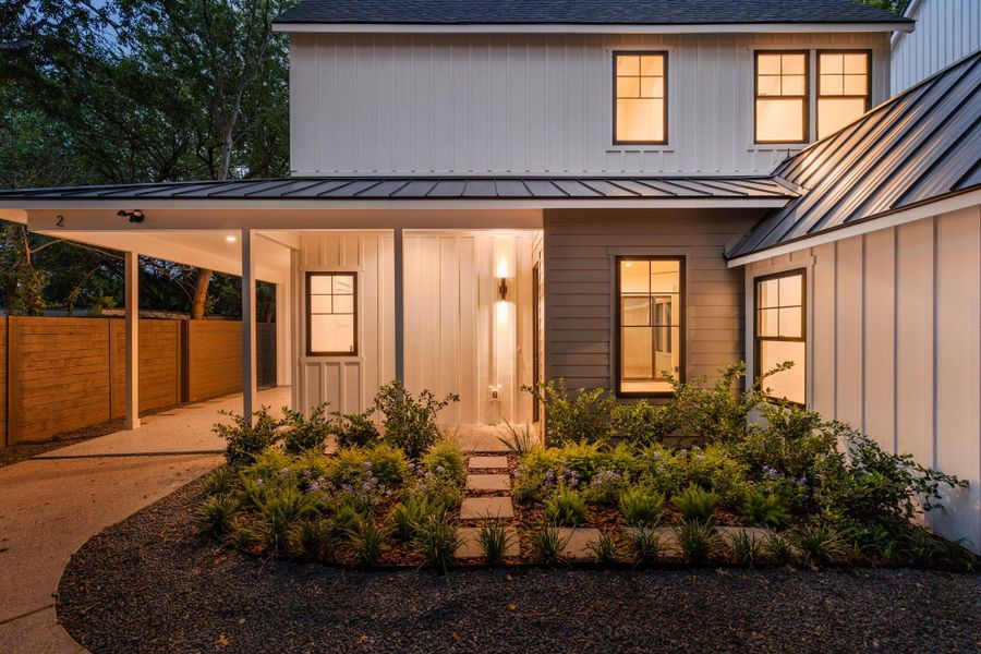 Doorway to property featuring board and batten siding, an attached carport, a standing seam roof, and roof with shingles Doorway to property featuring board and batten siding, an attached carport, a standing seam roof, and roof with shingles