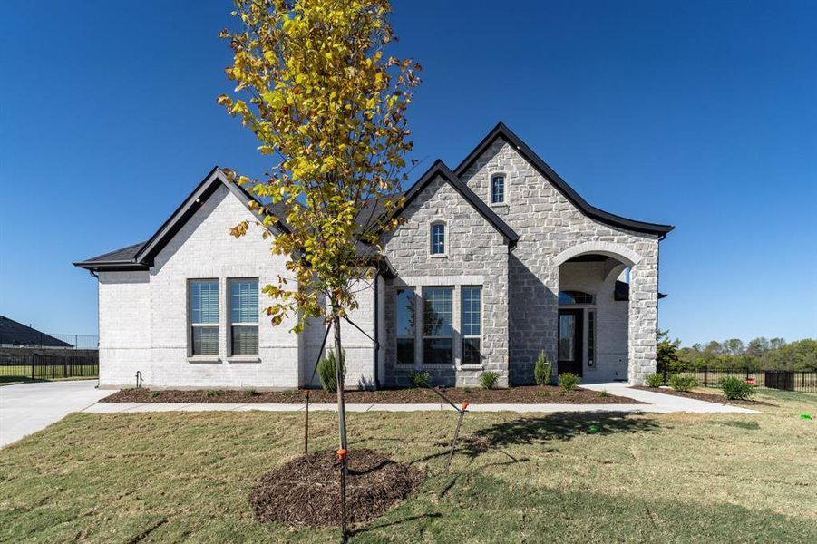 Front exterior of a new home in Heath Golf & Yacht Club, Heath, TX, highlighting curb appeal (Image 2). Front exterior of a new home in Heath Golf & Yacht Club, Heath, TX, highlighting curb appeal (Image 2).