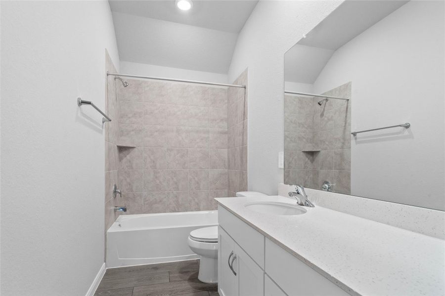 A streamlined secondary bathroom providing a functional tub/shower combination and modern fixtures, seamlessly blending practicality and style.