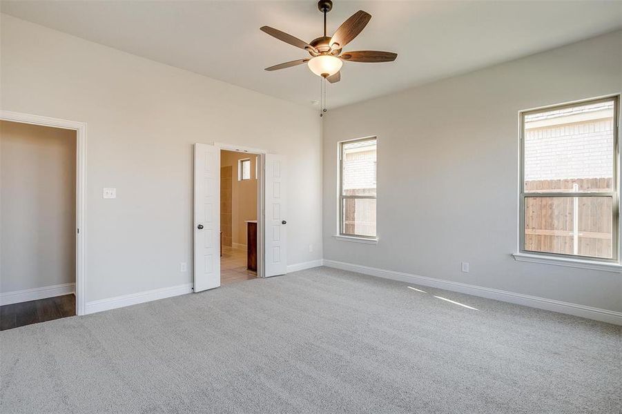 Unfurnished bedroom featuring carpet and ceiling fan