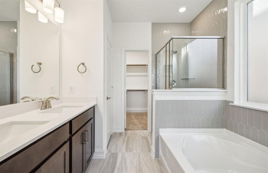 Spacious owner's bathroom with dual vanity and oversized shower *real home pictured