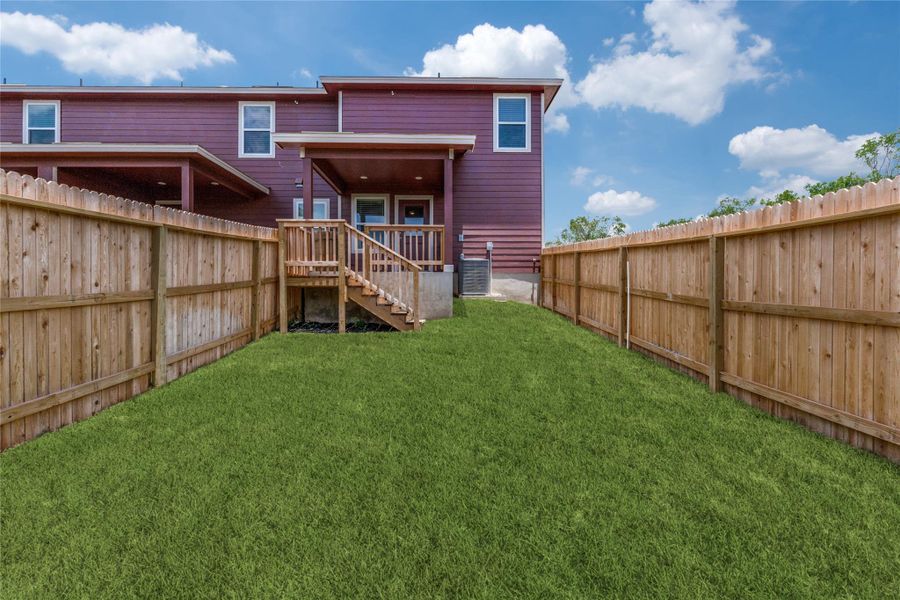 Rear view of house featuring stairs and a fenced backyard Rear view of house featuring stairs and a fenced backyard