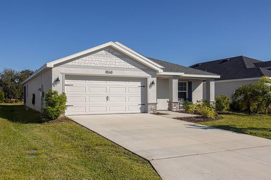 Front exterior of a new home in , Parrish, FL, highlighting curb appeal (Image 1).