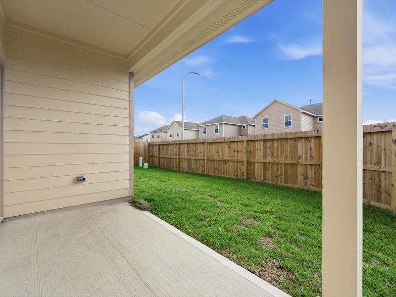 Enjoy outdoor living from the covered back patio, perfect for relaxing evenings and weekend gatherings.