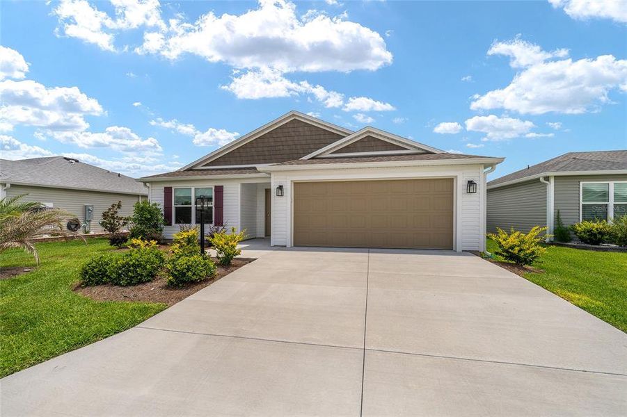 Front exterior of a new home in , The Villages, FL, highlighting curb appeal (Image 21).