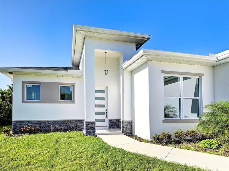 Front exterior of a new home in , Rotonda West, FL, highlighting curb appeal (Image 24).