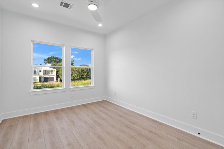 Durable and stylish LVP flooring flows seamlessly throughout the entire home, including all secondary bedrooms, creating a cohesive and modern look. Free from carpet, it’s easy to maintain while providing warmth and elegance underfoot. This thoughtful choice enhances the home’s open, airy feel and complements its Scandinavian-inspired design.