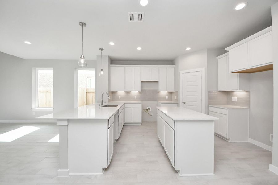All of this overlooks your expansive family room, creating a perfect space for culinary delights and family gatherings. Sample photo of completed home with similar floor plan. Actual colors and selections may vary.